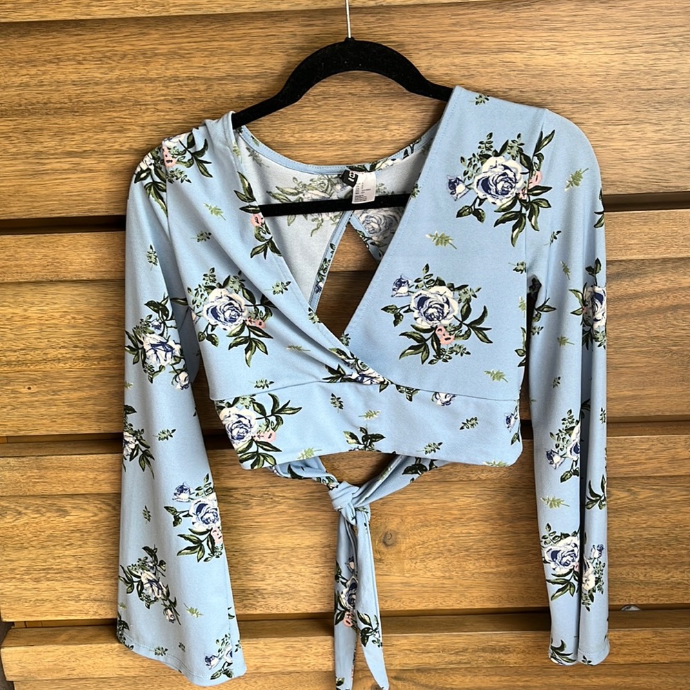 Low V, open back, long sleeve floral shirt.